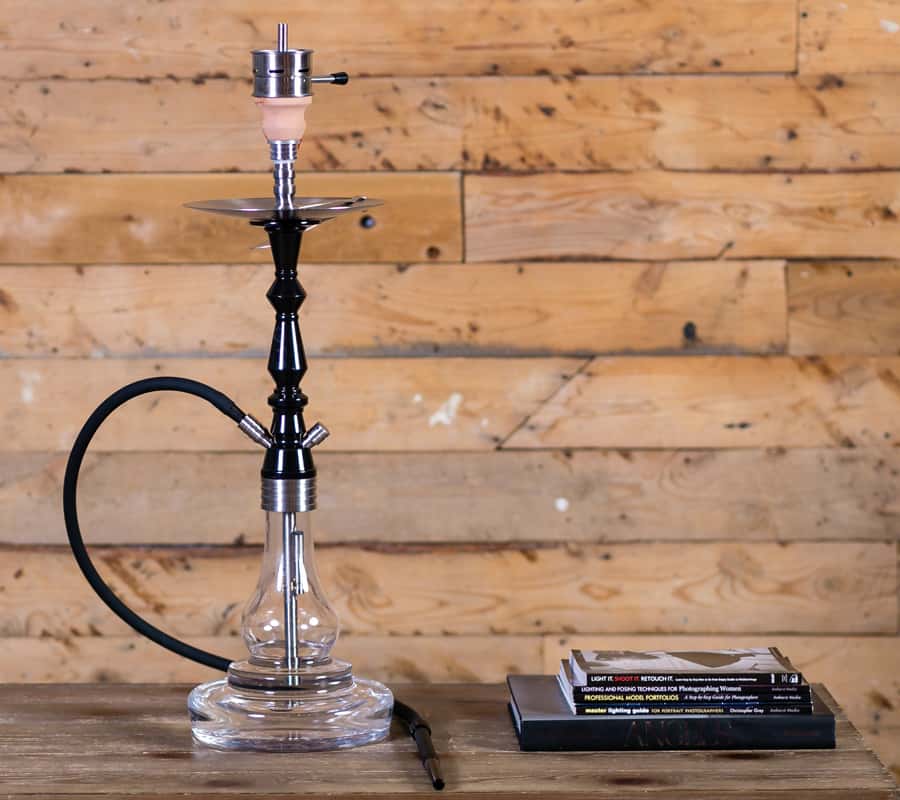 Glass hookah on wooden coffee table